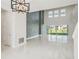Bright, open-concept living room features soaring ceilings, unique accent wall, and glossy marble flooring at 9201 Sanders Tree Loop, Wesley Chapel, FL 33545