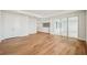 Spacious living room with hardwood floors, sliding glass door and closet at 9201 Sanders Tree Loop, Wesley Chapel, FL 33545