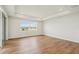 Spacious living room boasts recessed lighting, wood flooring, and scenic views through a large window at 9201 Sanders Tree Loop, Wesley Chapel, FL 33545
