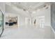 Expansive open floor plan featuring high ceilings and a view of the modern kitchen at 9201 Sanders Tree Loop, Wesley Chapel, FL 33545