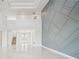 Bright open-concept living area features high ceilings and an eye-catching decorative wall at 9201 Sanders Tree Loop, Wesley Chapel, FL 33545