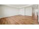 Hardwood floor living room featuring recessed lights, closet, and light-colored walls at 9201 Sanders Tree Loop, Wesley Chapel, FL 33545