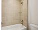 Shower featuring decorative tiling, shower head, built in shelves and a bathtub at 9201 Sanders Tree Loop, Wesley Chapel, FL 33545