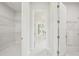 Spacious walk-in closet featuring custom shelving and marble flooring, perfect for organized storage at 9201 Sanders Tree Loop, Wesley Chapel, FL 33545