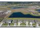 Aerial view of a neighborhood showcasing modern homes and community ponds, providing a scenic and connected environment at 17127 Harvest Moon Way, Bradenton, FL 34211