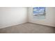 Bedroom features neutral paint, carpet, and views of the lake at 17127 Harvest Moon Way, Bradenton, FL 34211