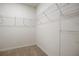 Spacious walk-in closet with ample shelving for organized storage and neutral carpet flooring at 17127 Harvest Moon Way, Bradenton, FL 34211