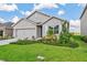 Charming single-story home with a manicured lawn and inviting curb appeal and attached garage at 17127 Harvest Moon Way, Bradenton, FL 34211