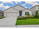 Charming single-story home featuring a well-maintained lawn, beautiful landscaping, and a two-car garage at 17127 Harvest Moon Way, Bradenton, FL 34211