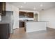 Well-equipped kitchen featuring stainless steel appliances, dark wood cabinets, and sleek countertops at 17127 Harvest Moon Way, Bradenton, FL 34211