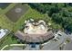 Aerial shot of a luxurious community pool area surrounded by lush landscaping and amenities at 17127 Harvest Moon Way, Bradenton, FL 34211