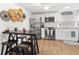 Kitchen with stainless steel appliances, a modern bar-style dining area, and decorative wall art at 5141 Mallet Dr, Port Richey, FL 34668