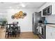 Kitchen with stainless steel appliances, a modern bar-style dining area, and decorative wall art at 5141 Mallet Dr, Port Richey, FL 34668