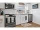 Bright kitchen features stainless steel appliances, white cabinets, granite countertops, and wood-look flooring at 5141 Mallet Dr, Port Richey, FL 34668