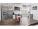 Modern kitchen featuring stainless steel appliances, white cabinets, and stylish backsplash at 5141 Mallet Dr, Port Richey, FL 34668