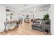 Open-concept living room with natural light, modern furniture, and wood flooring at 5141 Mallet Dr, Port Richey, FL 34668