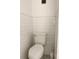 The modern bathroom features tiled walls and a well-maintained toilet with efficient plumbing at 821 Patricia Ave # 202, Dunedin, FL 34698