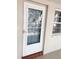Front door with glass insert and an adjacent window allowing for plenty of natural light at 821 Patricia Ave # 202, Dunedin, FL 34698