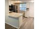 Updated kitchen featuring a breakfast bar, stainless steel appliances, and modern countertops at 821 Patricia Ave # 202, Dunedin, FL 34698