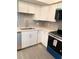 Updated kitchen with stainless steel appliances, modern countertops, and decorative backsplash at 821 Patricia Ave # 202, Dunedin, FL 34698
