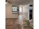 Open living room with wood floors and natural light, showcasing the home's layout at 821 Patricia Ave # 202, Dunedin, FL 34698