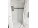 Shower stall with a decorative tile border, featuring tiled shower with a rainfall shower head at 821 Patricia Ave # 202, Dunedin, FL 34698