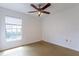 A vacant room with a ceiling fan and a window providing natural light at 7814 34Th E Ct, Sarasota, FL 34243
