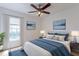 Comfortable bedroom featuring stylish decor, soft carpet, and an illuminated ceiling fan at 7814 34Th E Ct, Sarasota, FL 34243