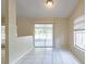 Bright dining area with sliding glass doors to the outside and white tile floors at 7814 34Th E Ct, Sarasota, FL 34243