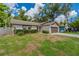 Inviting single-story home featuring a two-car garage, simple landscaping, and side yard fence at 7814 34Th E Ct, Sarasota, FL 34243