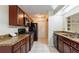 Functional kitchen with granite countertops, wood cabinetry, and modern black appliances at 7814 34Th E Ct, Sarasota, FL 34243