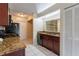 Well-lit kitchen with granite countertops, stainless steel sink, and black appliances at 7814 34Th E Ct, Sarasota, FL 34243