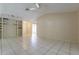 Open living room with tile flooring and neutral walls offers a blank canvas for personalization at 7814 34Th E Ct, Sarasota, FL 34243