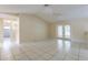 Spacious living room featuring vaulted ceilings, tile floors, and glass doors to the backyard at 7814 34Th E Ct, Sarasota, FL 34243
