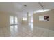 Bright and airy living room with tile flooring and open layout to the dining area at 7814 34Th E Ct, Sarasota, FL 34243