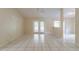 Bright living room with tile flooring, ceiling fan, and glass doors leading to the backyard at 7814 34Th E Ct, Sarasota, FL 34243