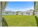 Spacious backyard with lush green grass and neighboring homes at 11923 Boynton Ln # B, New Port Richey, FL 34654
