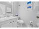 Bathroom featuring a large vanity with a white sink, a toilet and a wall cabinet for storage at 11923 Boynton Ln # B, New Port Richey, FL 34654