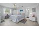 Inviting bedroom features a ceiling fan and direct access to the adjacent bathroom at 11923 Boynton Ln # B, New Port Richey, FL 34654