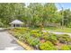 Summertree community entrance with lush flowerbeds and a charming guard house at 11923 Boynton Ln # B, New Port Richey, FL 34654