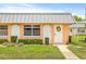Charming single-story home with a well-manicured lawn, decorative accents, and inviting front door at 11923 Boynton Ln # B, New Port Richey, FL 34654