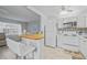 Modern kitchen with white cabinetry, breakfast bar, and seamless flow to the living area, perfect for entertaining at 11923 Boynton Ln # B, New Port Richey, FL 34654