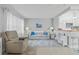 Cozy living room with comfortable seating, natural light, and open layout seamlessly connecting to the kitchen at 11923 Boynton Ln # B, New Port Richey, FL 34654