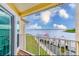 A balcony overlooks a waterfront view with a boat dock and calm water, framed by lush greenery at 150 Brent Cir, Oldsmar, FL 34677