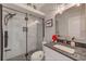 Updated bathroom with a walk-in shower with glass surround and granite vanity at 150 Brent Cir, Oldsmar, FL 34677