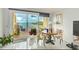 Cozy dining area with waterfront view, table, chairs, and access to private deck at 150 Brent Cir, Oldsmar, FL 34677
