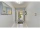Bright foyer with a glass front door and white tile floors that leads into the home at 150 Brent Cir, Oldsmar, FL 34677