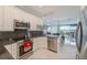Updated kitchen with granite countertops, stainless appliances, and breakfast bar overlooking the water at 150 Brent Cir, Oldsmar, FL 34677