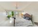 Serene primary bedroom with water views, a private balcony, and ample natural light at 150 Brent Cir, Oldsmar, FL 34677