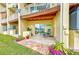 Outdoor patio with stone floors, lush landscaping, and water views at 150 Brent Cir, Oldsmar, FL 34677